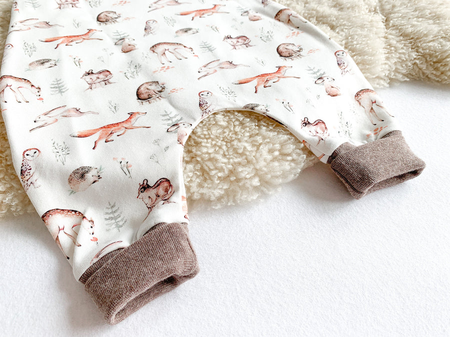 Babystrampler mit Waldtieren, Fuchs, Reh, Igel, Hase Eule und Bär. Farben rostrot und braun. Passende Bündchen in braun.
